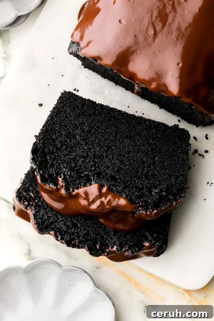 slice of black cocoa loaf cake with chocolate ganache