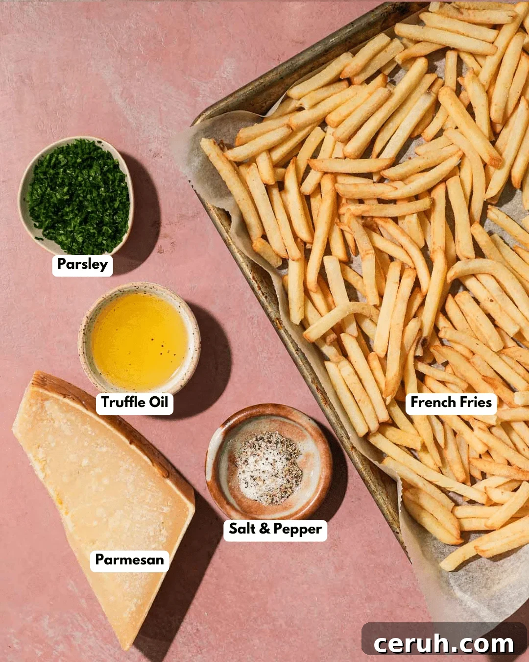 Crispy Parmesan Truffle Fries Recipe — Golden, Flavorful Fries 3 A tray of golden French fries with bowls of truffle oil, parsley, Parmesan, and salt & pepper.