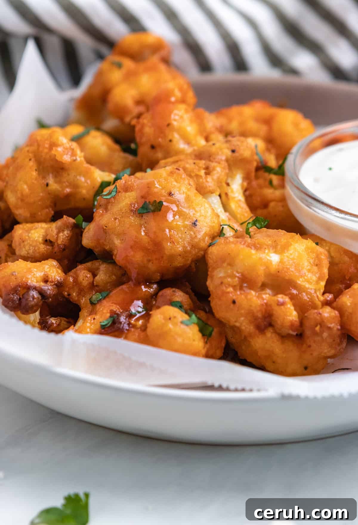Plate of air fryer buffalo cauliflower with fresh parsley.