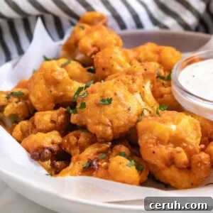 Air fryer buffalo cauliflower on plate with parsley.