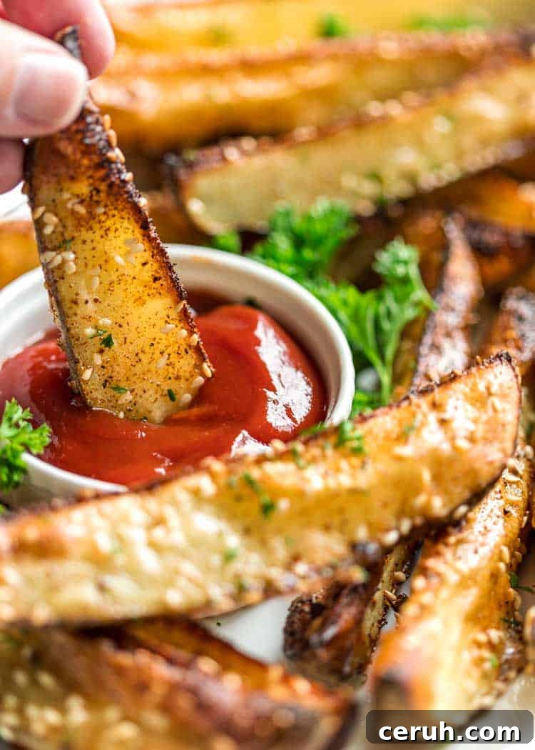 potato wedge dunked in catsup