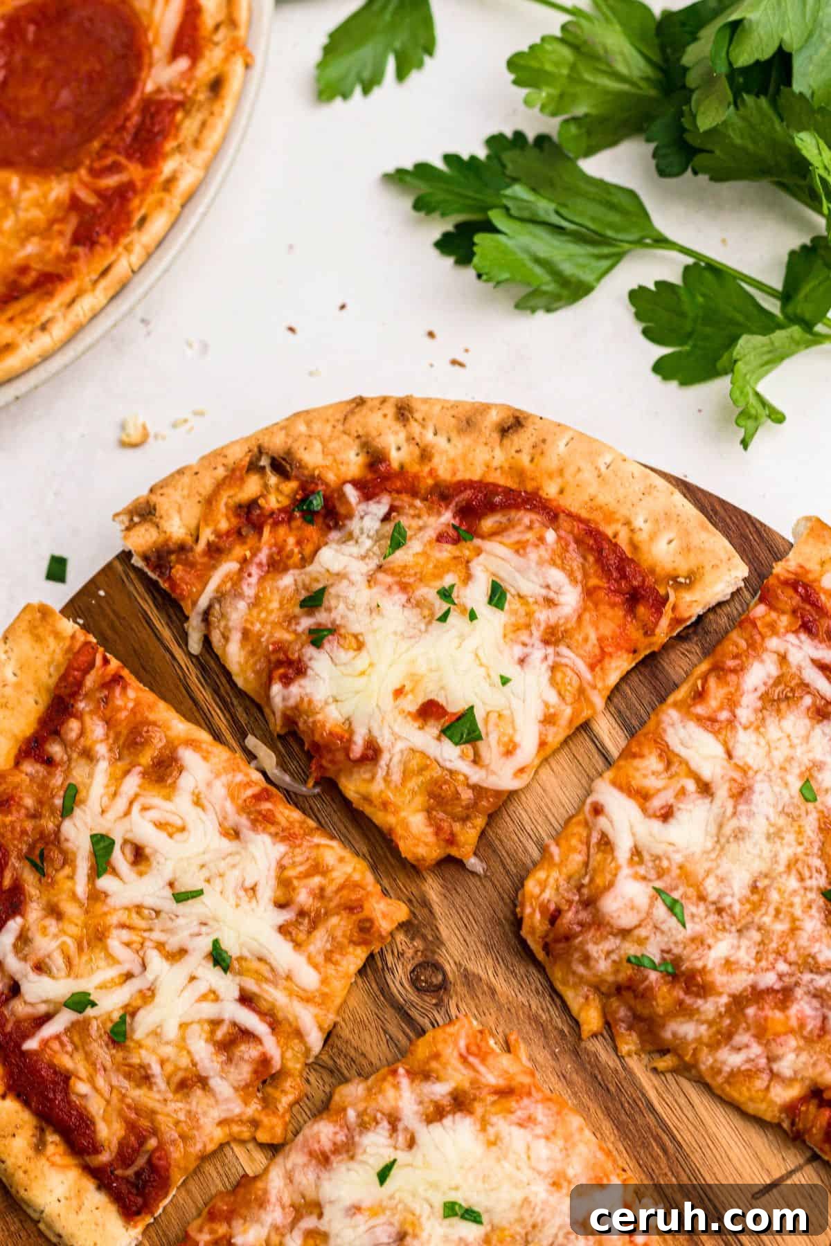 Cheesy pizza with a golden crust of pita bread on a cutting board on a marble table. 