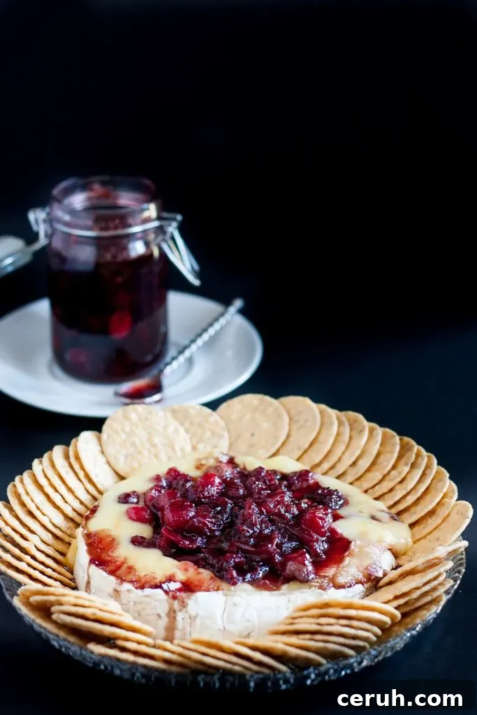 Baked brie is an impressive, yet easy holiday appetizer! This recipe tops the baked brie with a fresh cranberry balsamic compote that keeps you coming back for bite after bite!