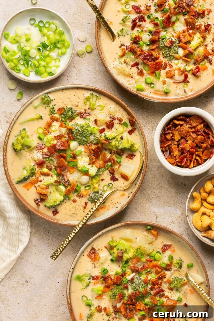 Creamy Dairy-Free Loaded Baked Potato Soup Recipe 8 three bowls filled with dairy free loaded potato soup and garnished with bacon and green onion