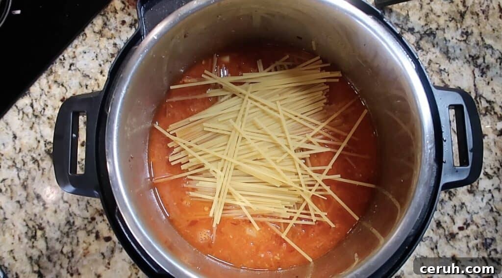 Instant Pot Linguine alla Parma: Creamy Prosciutto & Parmesan 21 Laying linguine in pot in a crisscoss fashion.