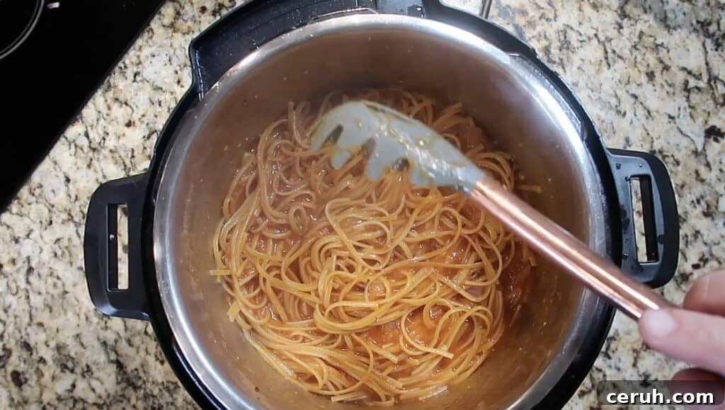 Instant Pot Linguine alla Parma: Creamy Prosciutto & Parmesan 22 Stirring cooked pasta