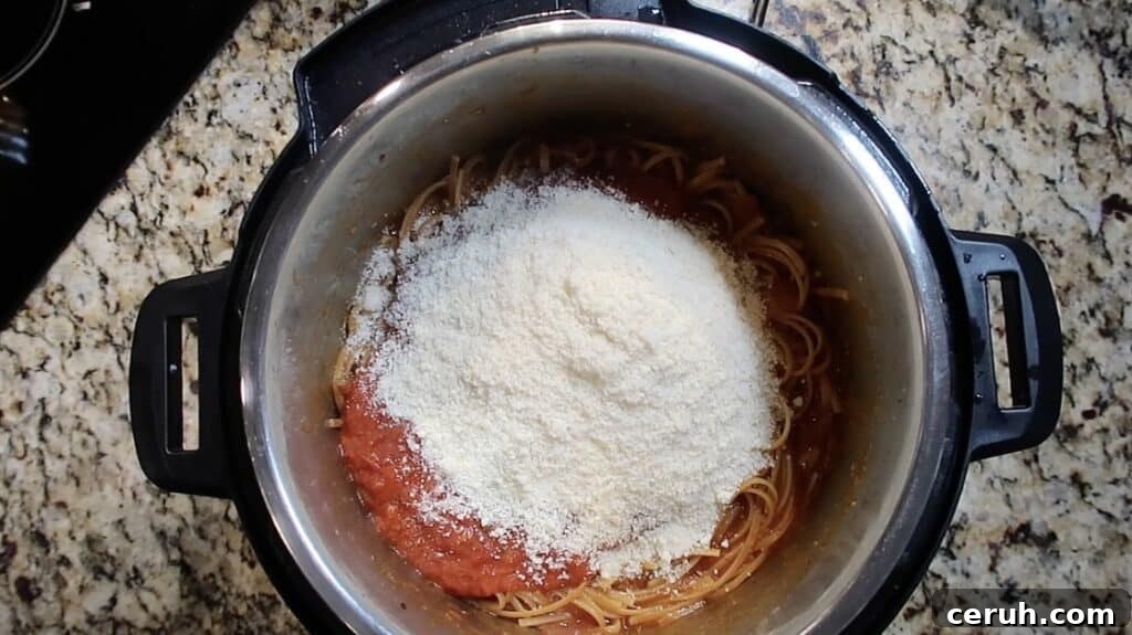 Instant Pot Linguine alla Parma: Creamy Prosciutto & Parmesan 25 Adding Parmesan to pot