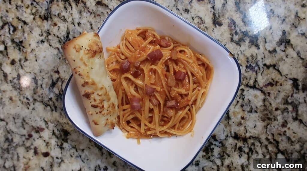 Instant Pot Linguine alla Parma: Creamy Prosciutto & Parmesan 28 Serving pasta in bowl with a cheese stick.