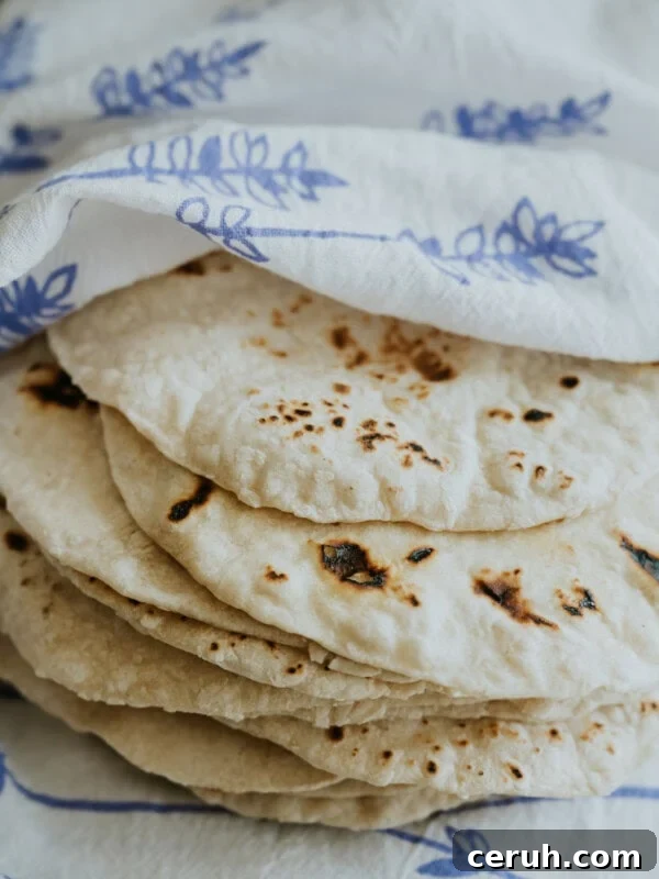 homemade flour tortillas recipe by Yvette Marquez-Sharpnack stacked warm in towel
