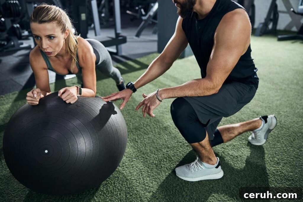 client using stability ball while trainer gives pointers