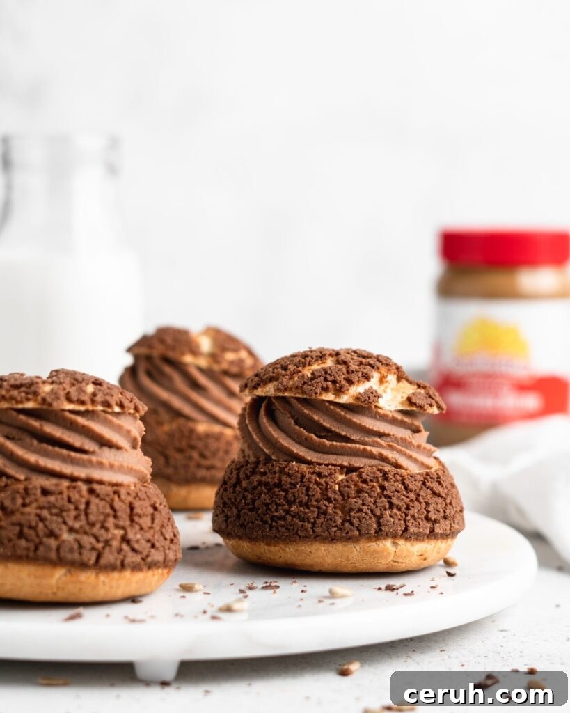 Cream puffs topped with a chocolate craquelin, filled with a creamy SunButter Milk Chocolate whipped ganache filling