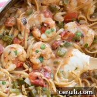 Closeup of recipe in pan so you can really see creamy sauce and texture of veggies and tender shrimp.