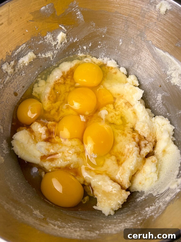Eggs on top of a sugar and butter base for a big batch of brownies