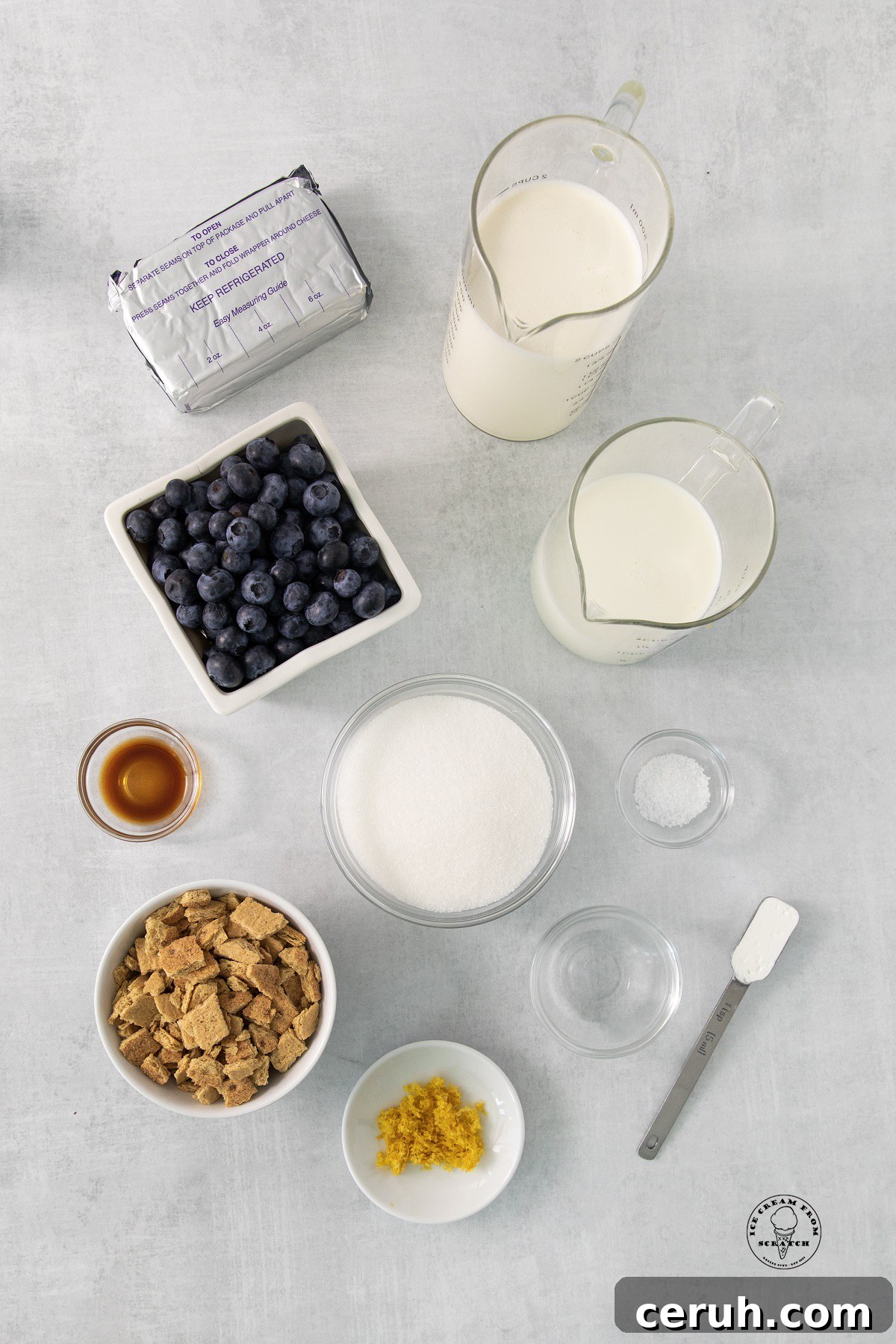 Blueberry Cheesecake Ice Cream Recipe — Creamy Homemade Treat 3 The ingredients for homemade blueberry cheesecake ice cream, all measured and arranged on a counter.