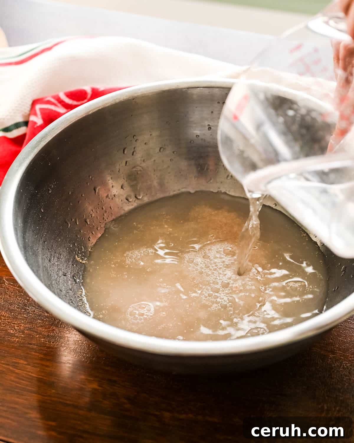 Adding water to the yeast.