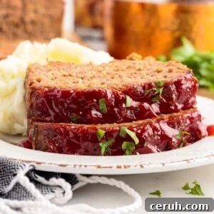 Close up of two slices of Lipton Onion Soup Meatloaf on a plate.