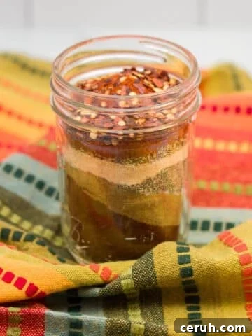 Glass jar of homemade taco seasoning mix.