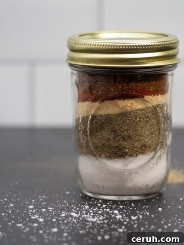 Glass jar filled with layers of spices.