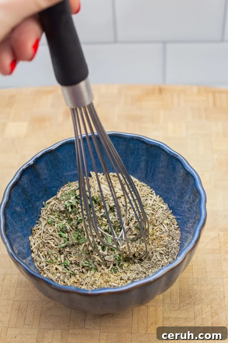 Whisking together ingredients for a homemade Italian seasoning blend.