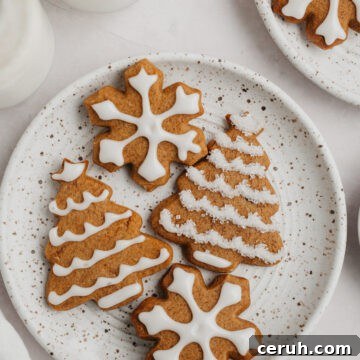 Iced gingerbread cookies on a plate.