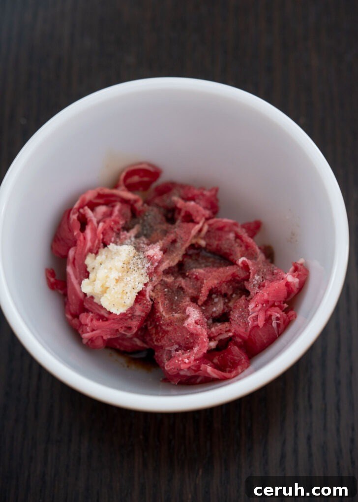 Mixing beef with seasoning in a bowl to make gungjung tteokbkki.