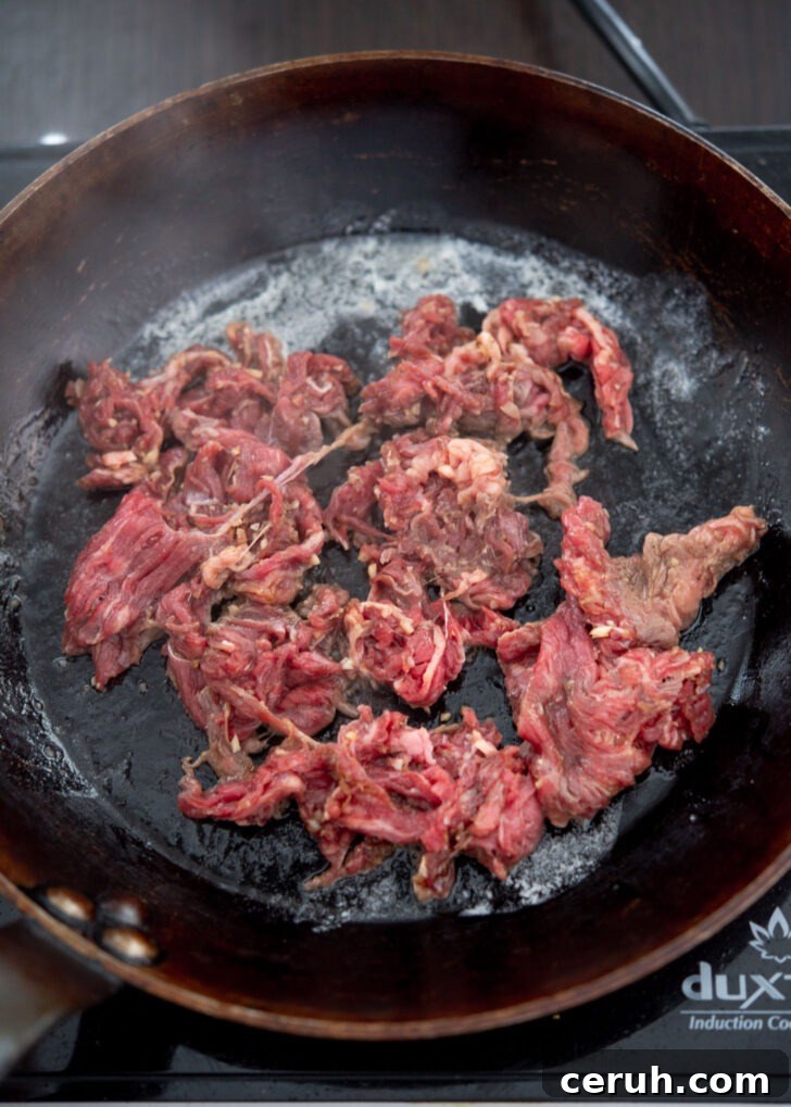 Browning beef in a skillet.