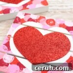 wood pallet coasters painted with a heart in the middle.