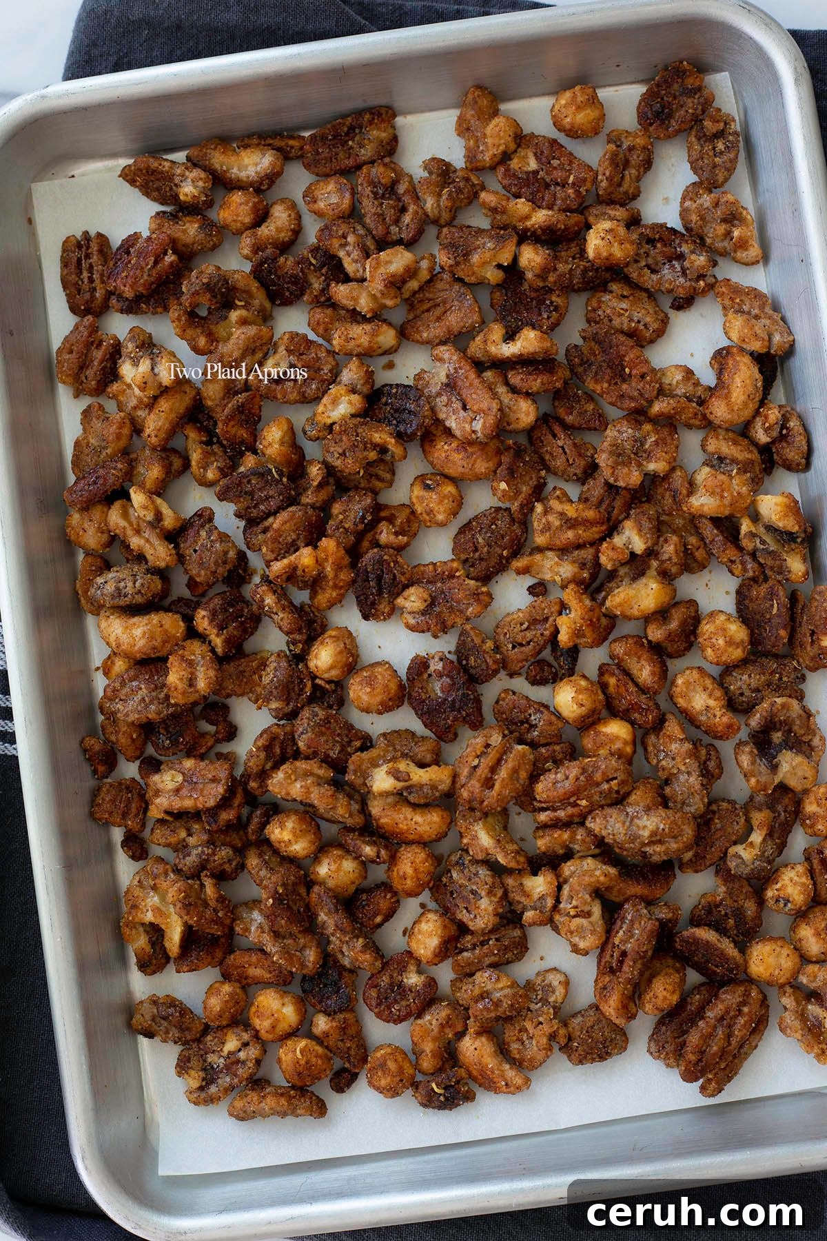 Spiced nuts cooling on baking sheet.