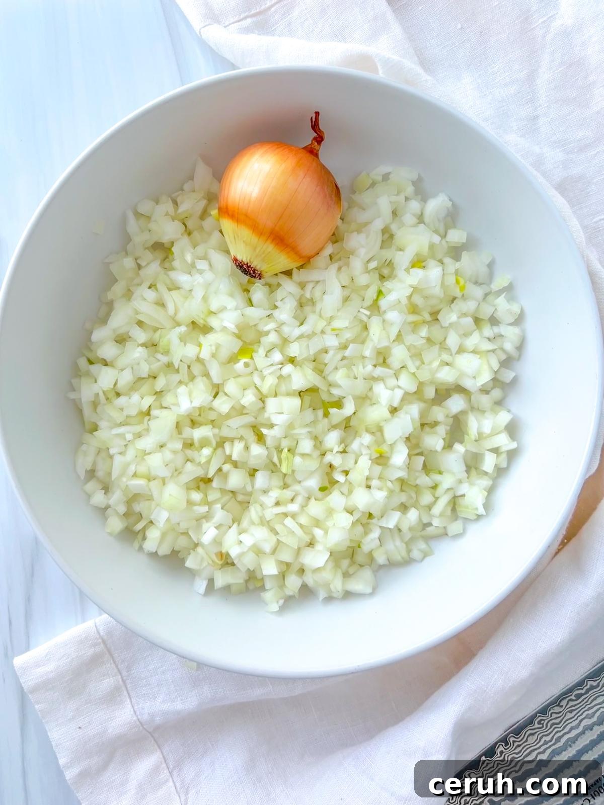 Master Diced Onion: Step-by-Step Guide for Perfect Cuts 2 How to Dice Onion - Bowl of diced onions, step-by-step onion cutting tutorial.