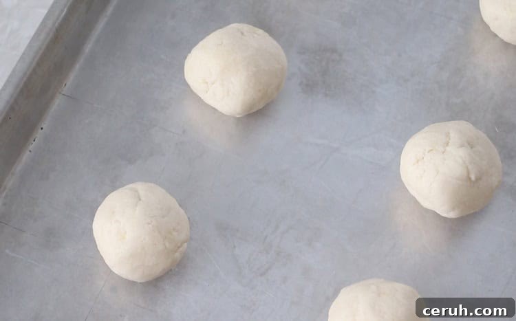 Lemon Sugar Cookies Recipe with Video Tutorial 6 balls of lemon sugar cookie dough on baking sheet