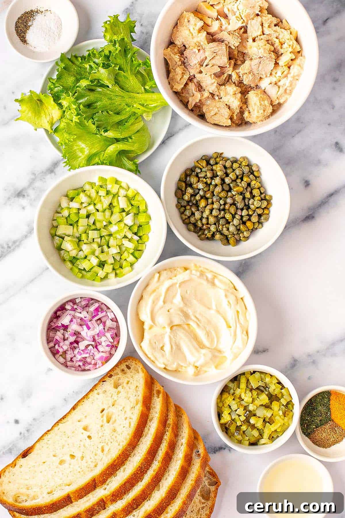 Bowls of ingredients to make tuna salad sandwiches.