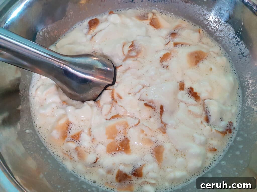 Blending ice cream mix with an immersion blender.
