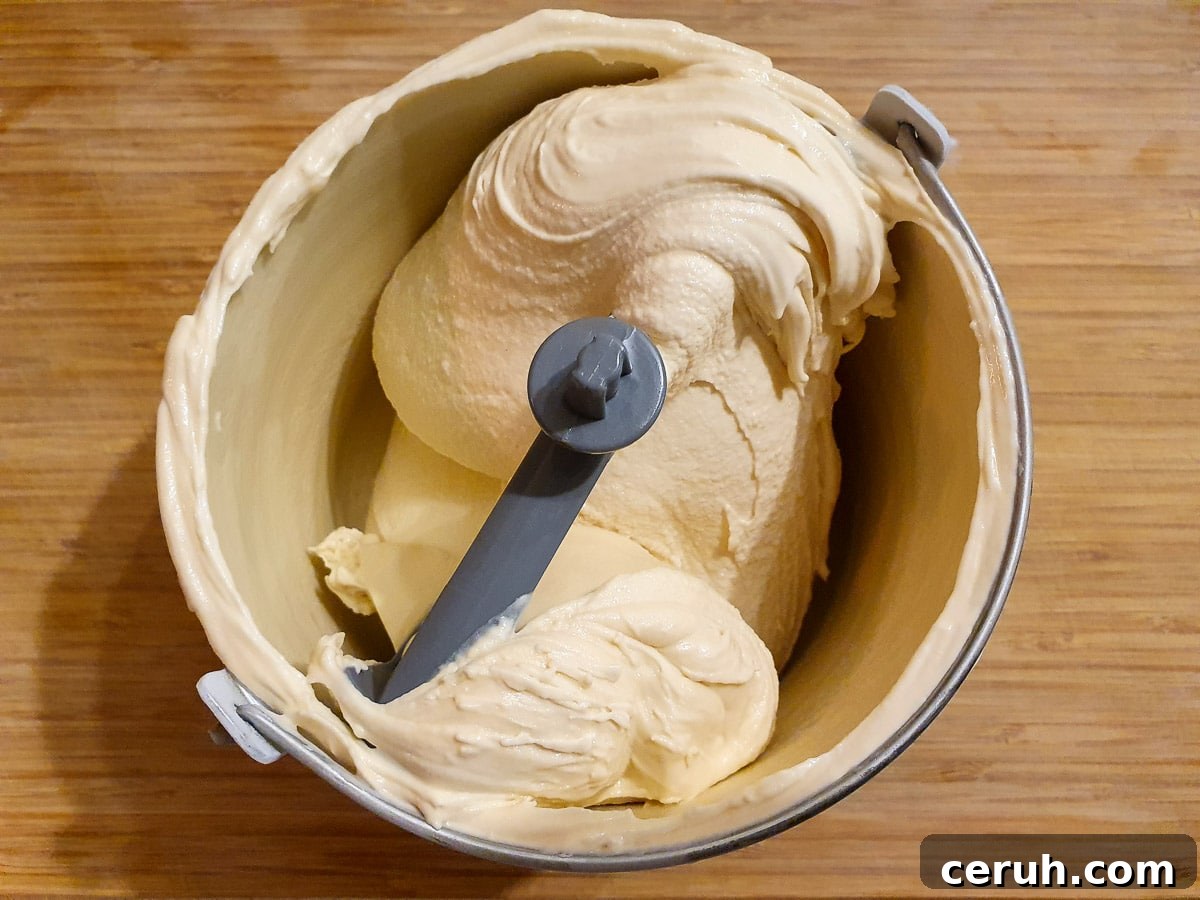 churned ice cream in churning bowl on a chopping board.