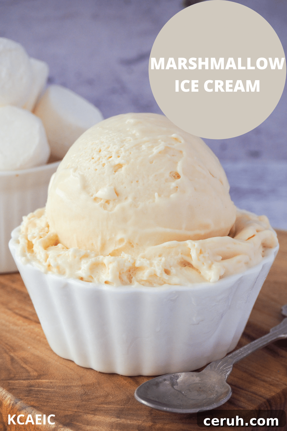 Scoop of marshmallow ice cream in a decorative white bowl, with vintage spoon on the side, bowl of marshmallows in the background and text overlay, marshmallow ice cream, KCAEIC.