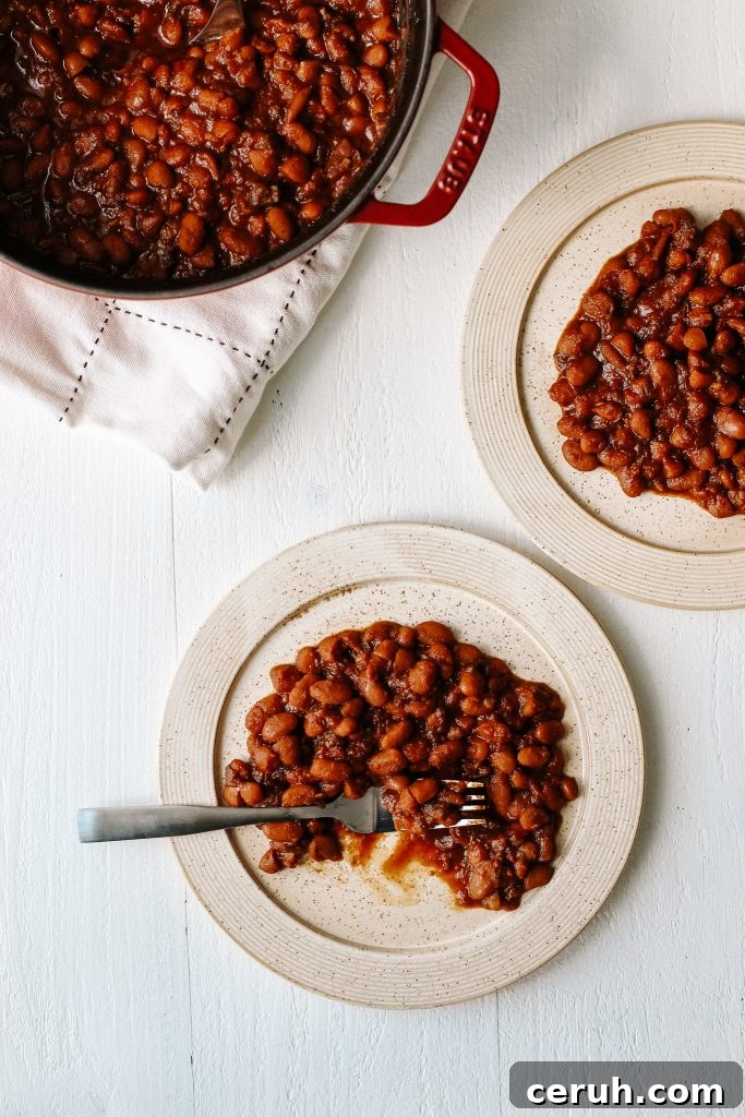 Vegan bbq baked beans on plate with fork and pot of beans