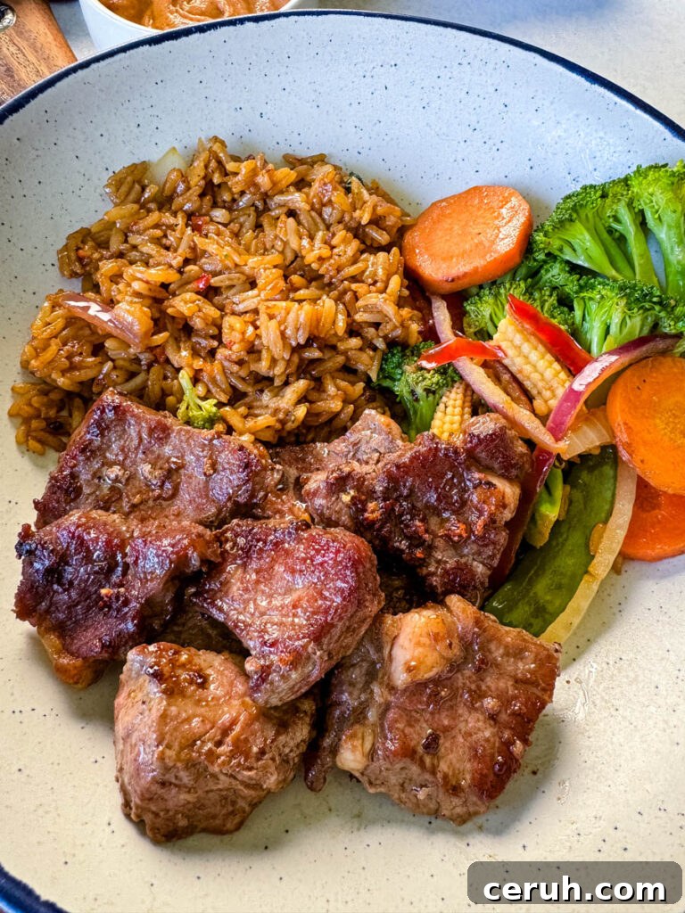 Hibachi Steak with Garlic Fried Rice Recipe 12 hibachi steak, vegetables, and fried rice in a white bowl