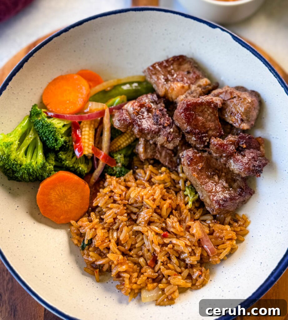 Hibachi Steak with Garlic Fried Rice Recipe 10 hibachi steak, vegetables, and fried rice in a white bowl