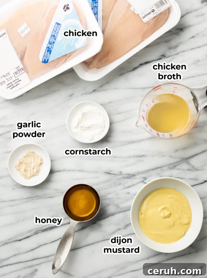 ingredients for baked honey mustard chicken in prep bowls on a counter