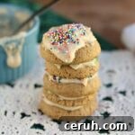 Four cookies on a table covered in healthy frosting.