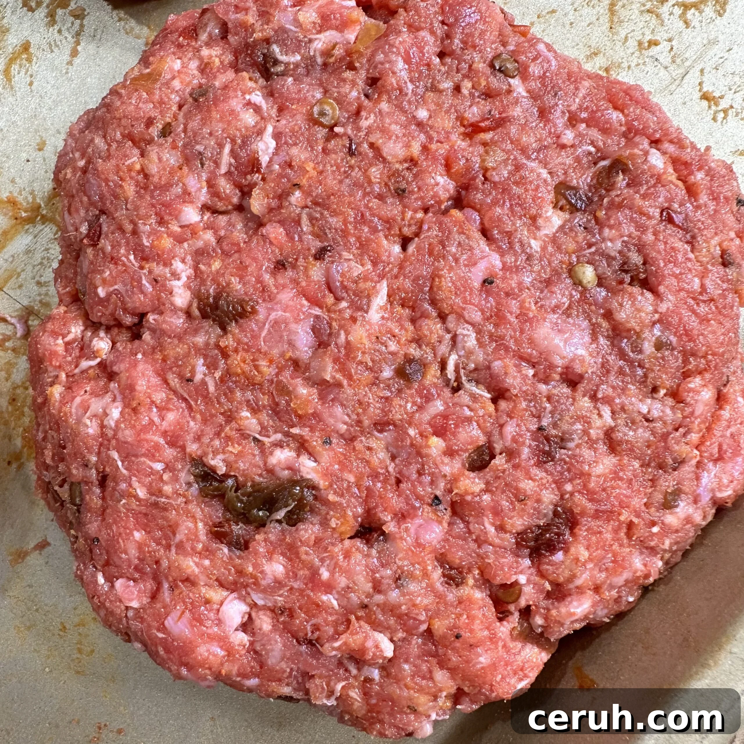 Raw Chipotle beef patty.