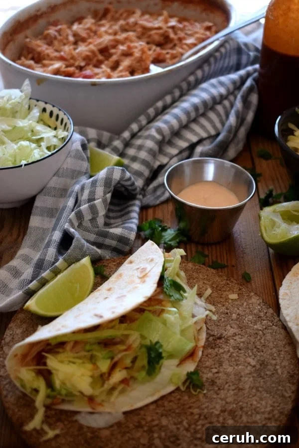 Slow-Cooker Shredded Chicken Tacos Recipe 2 table setting view of a taco dinner