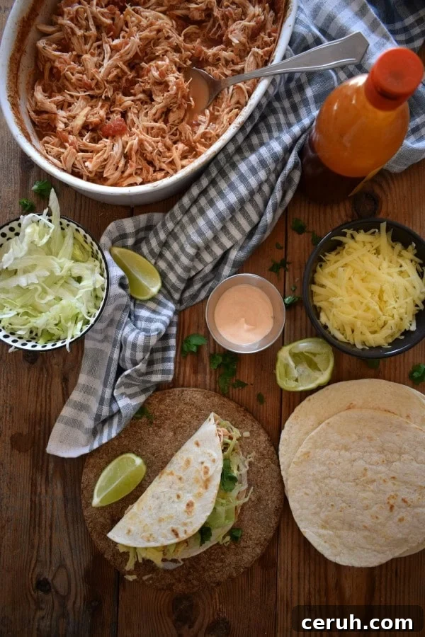 Slow-Cooker Shredded Chicken Tacos Recipe 3 over head view of a taco dinner