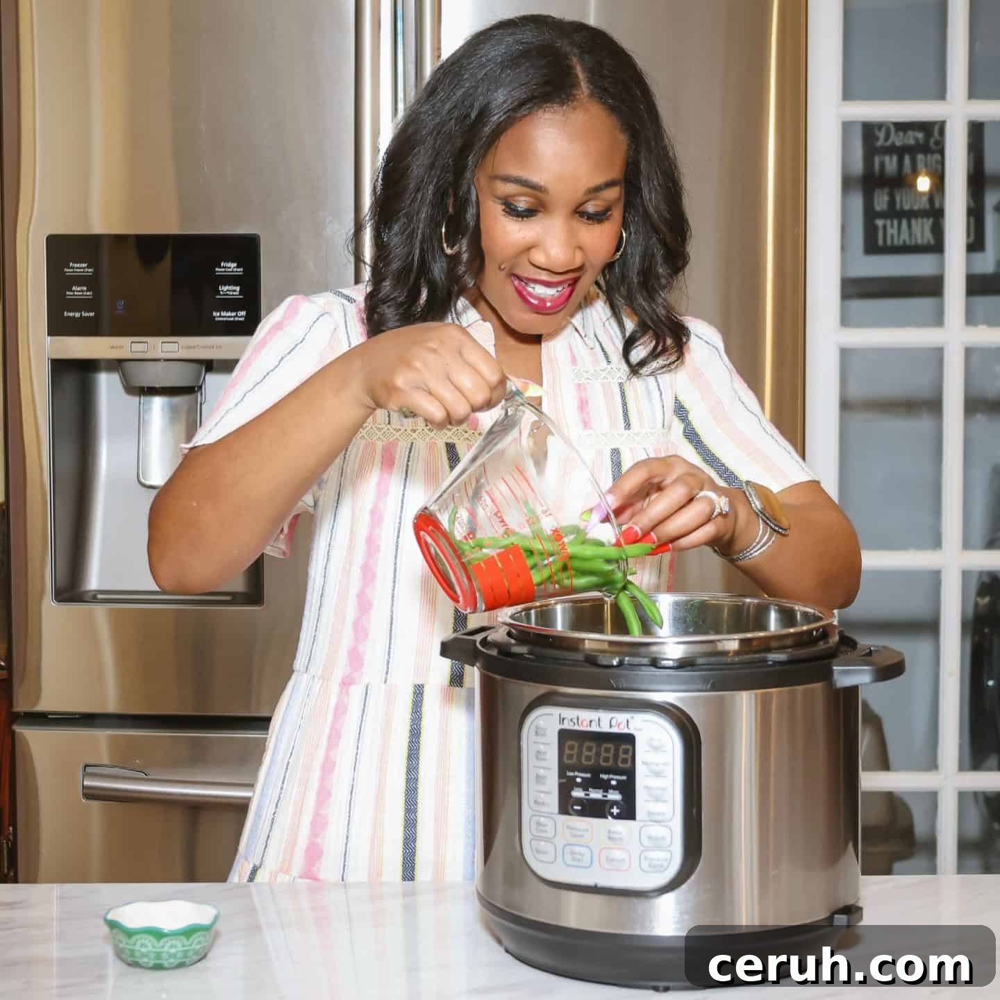 Shaunda Necole adding fresh green beans to an Instant Pot pressure cooker to make soul food green beans with layered soulful seasoning, from The Soul Food Pot®.