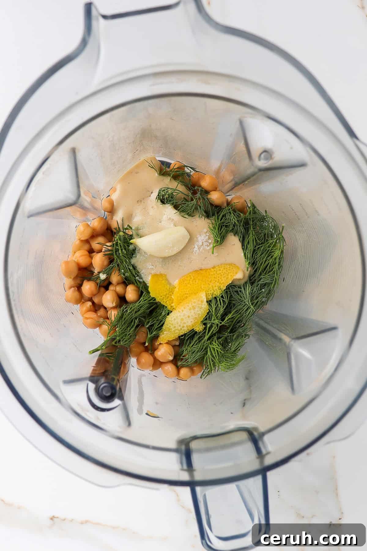 Ingredients to make hummus in a blender.
