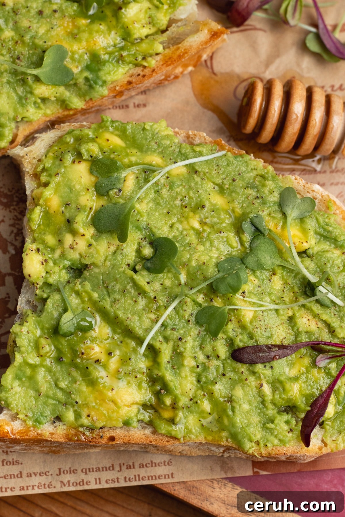 This is a picture of a toast with avocado and honey.