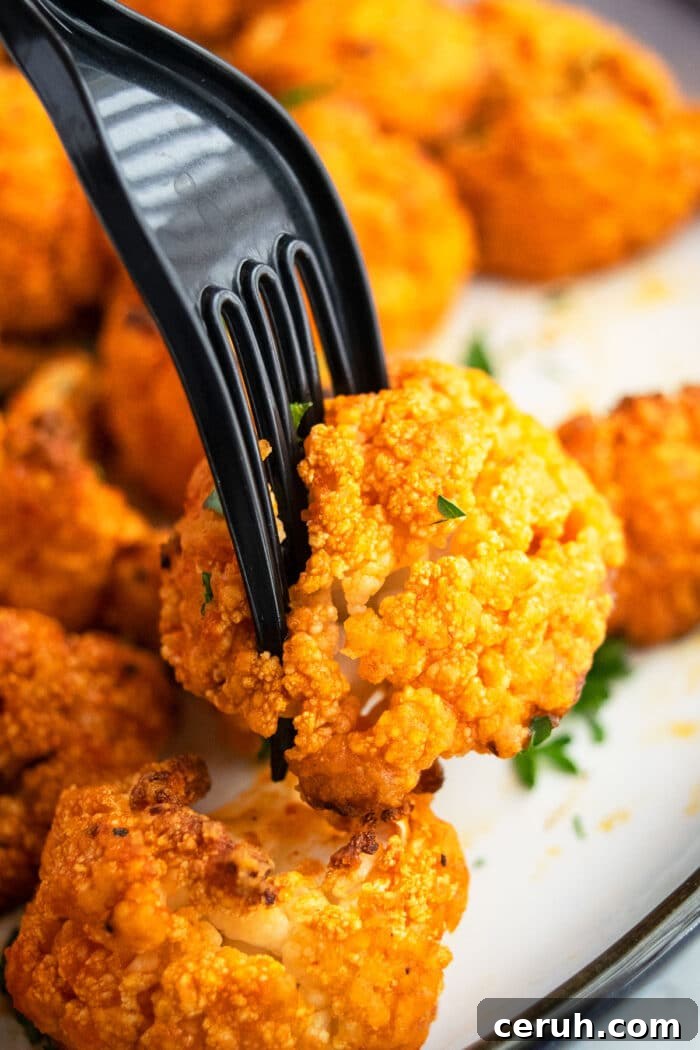Crispy Hot Wings on a Fork- Closeup Shot. 