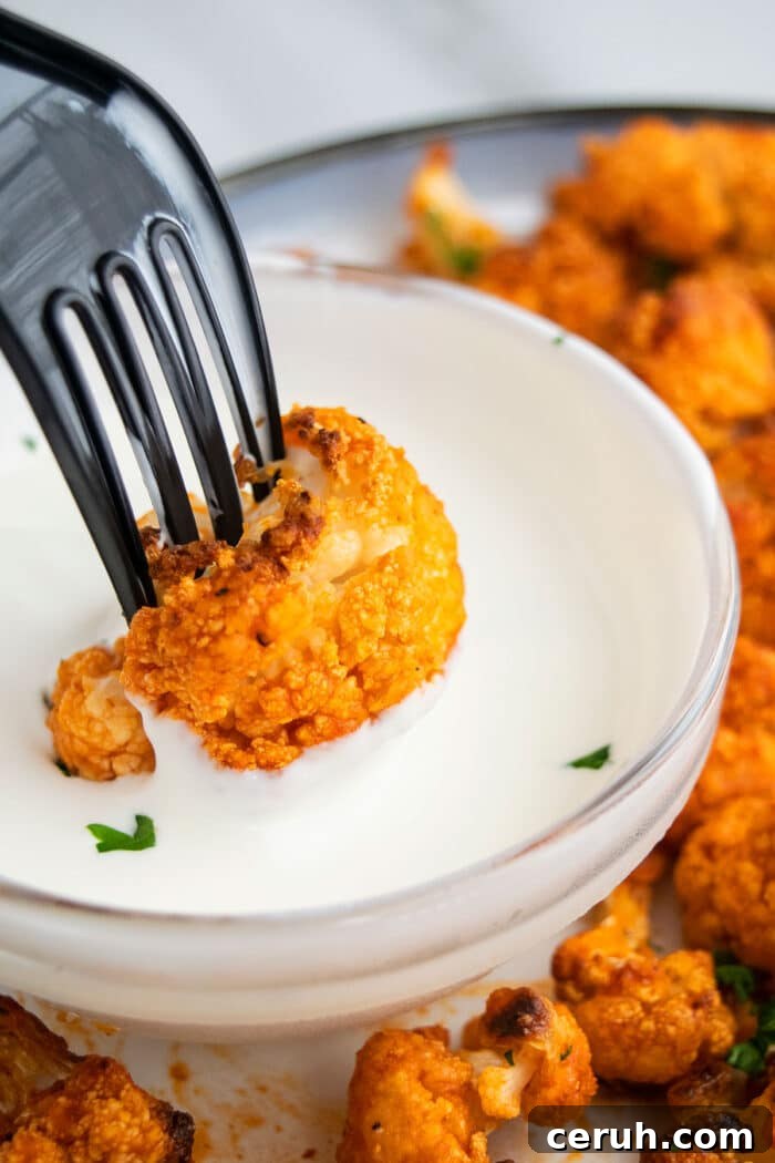 Vegetarian Wings Being Dipped In Bowl of Ranch Sauce.
