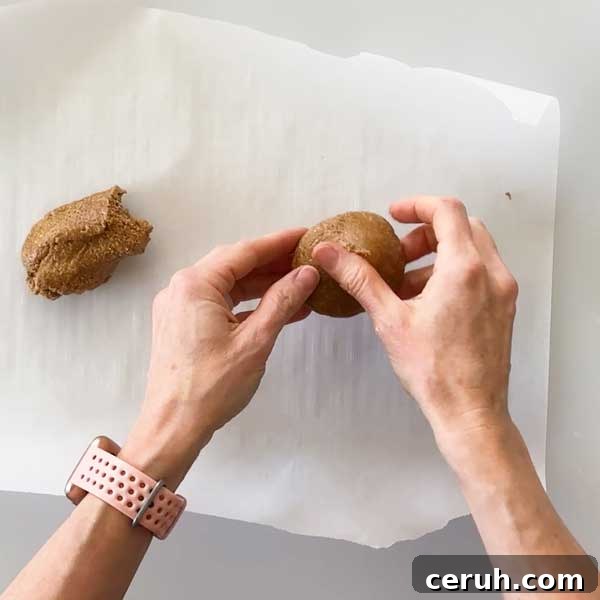 Gluten-Free Graham Cracker Crumbs for Baking and Desserts 5 Rolling the graham cracker batter in a ball over a parchment paper.