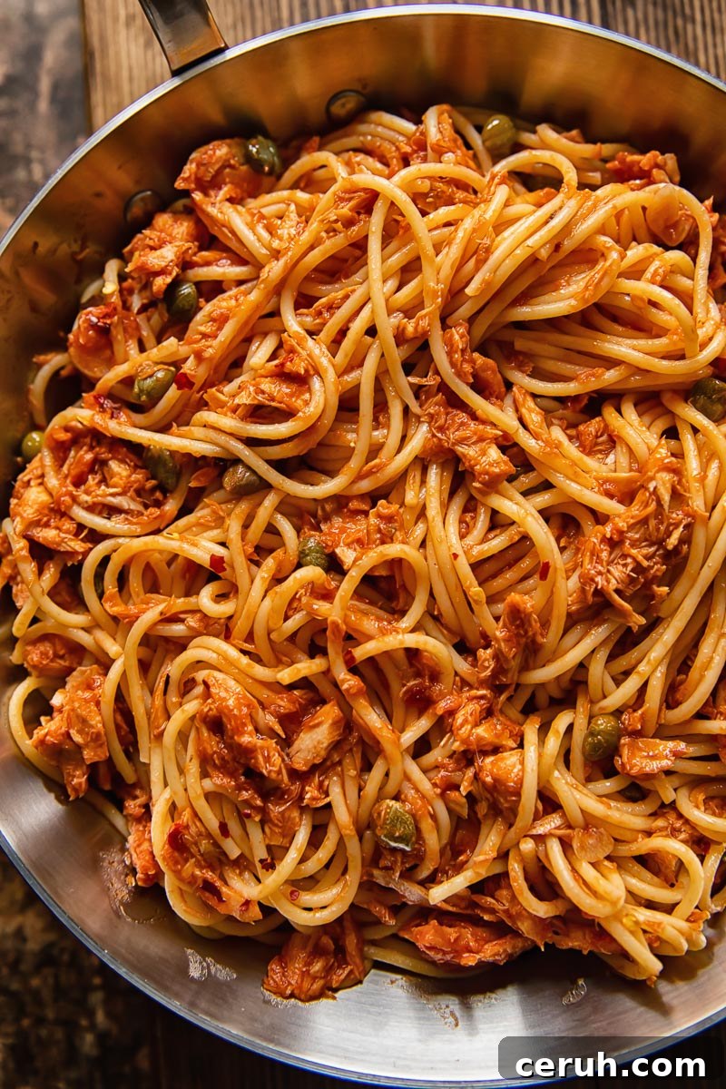 15-Minute Tuna Pasta with Capers and Lemon Zest 5 close up of spaghetti with tuna in a red sauce