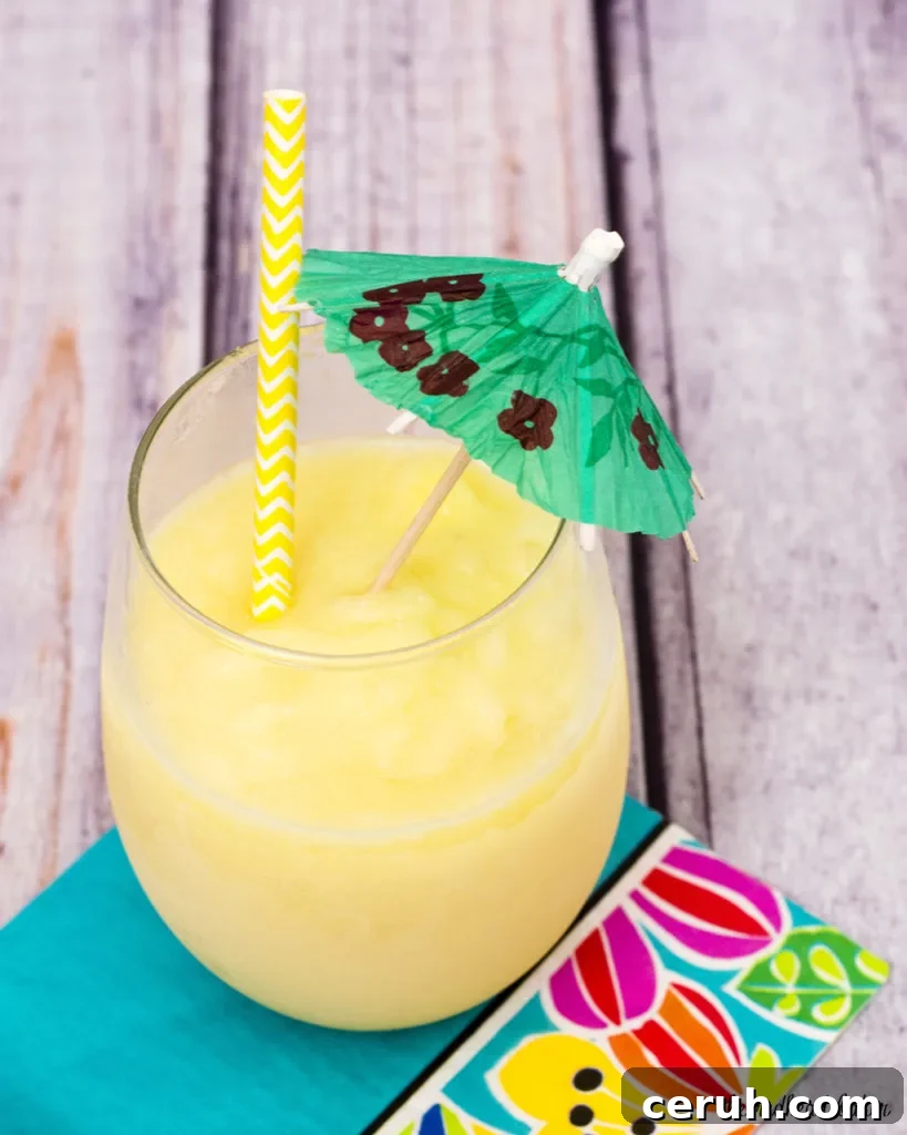 Frozen Piña Colada Recipe: Creamy Tropical Cocktail Guide 2 Have a taste of the tropics with a homemade frozen pina colada: a blend of ice, pineapple slices and juice, coconut cream and rum. #SundaySupper TheRedheadBaker.com